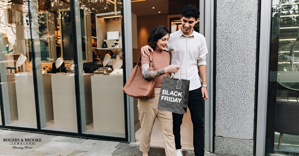 a boy and girl coming out of jewelry store by having shopping from black friday sale